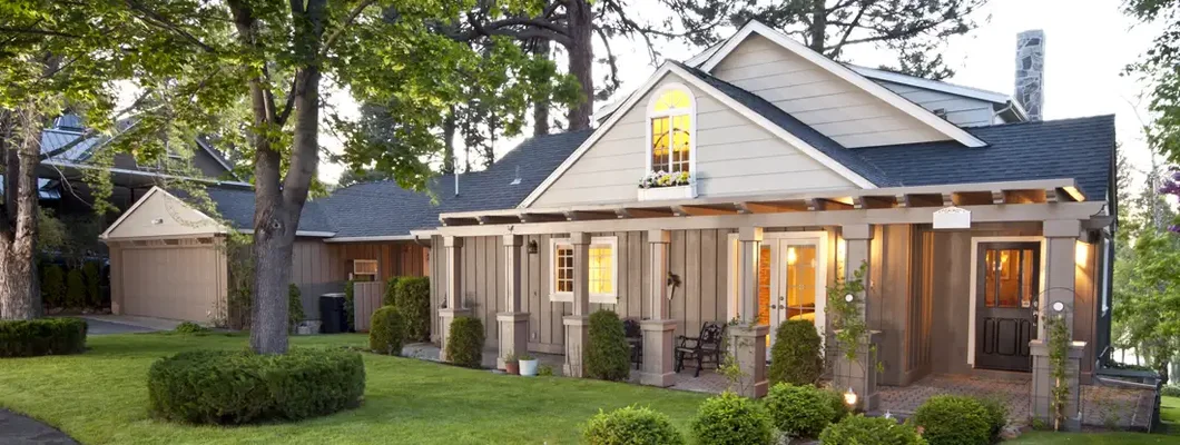 Home exterior with manicured lawn at twilight. Homeowners Insurance in Bellaire, Texas.