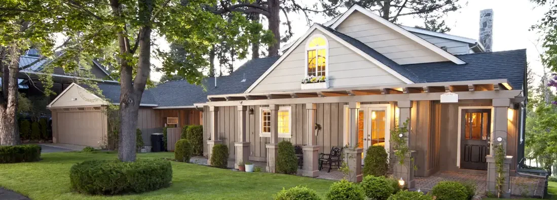 Home exterior with manicured lawn at twilight. Homeowners Insurance in Bellaire, Texas.