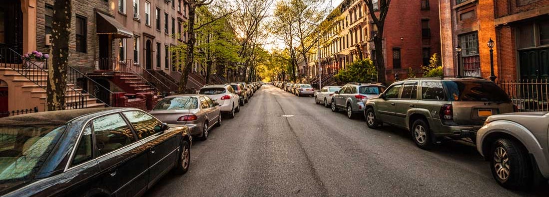 Boston brownstones on side street. Find Boston Massachusetts car insurance.