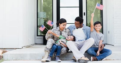 Female soldier is excited to be home with her family. Find Military and Veteran Home Discounts.