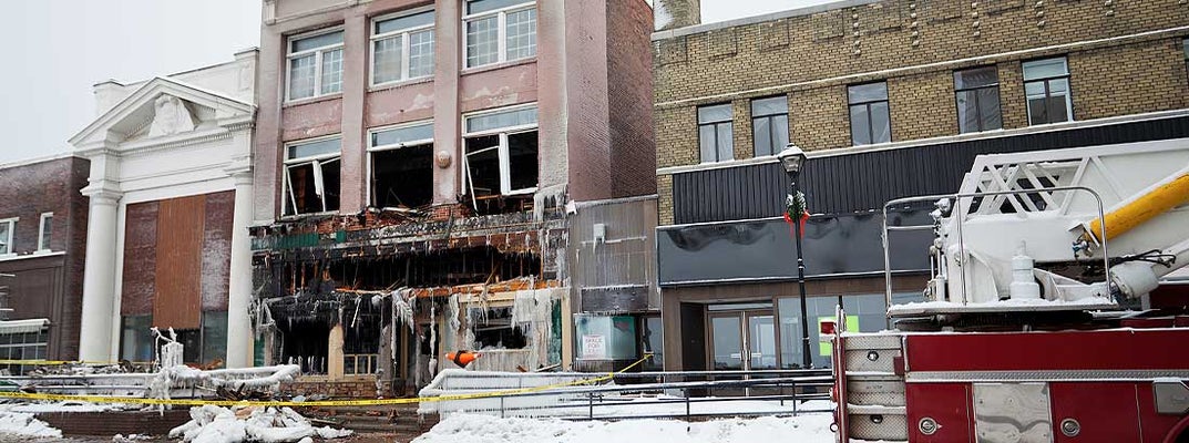Storefront of a business sits the morning after the fire. Find small business hazard insurance.