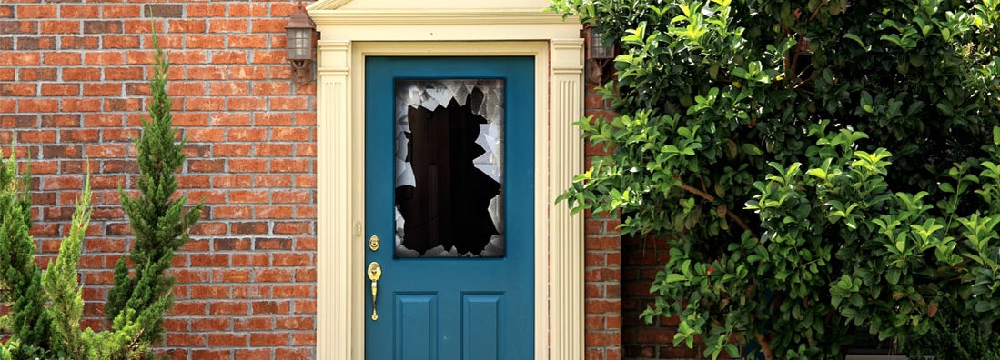 close up shot of broken door window glass of brick house