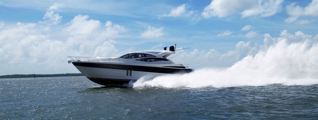 Yacht speeding on lake. Find Michigan boat insurance.