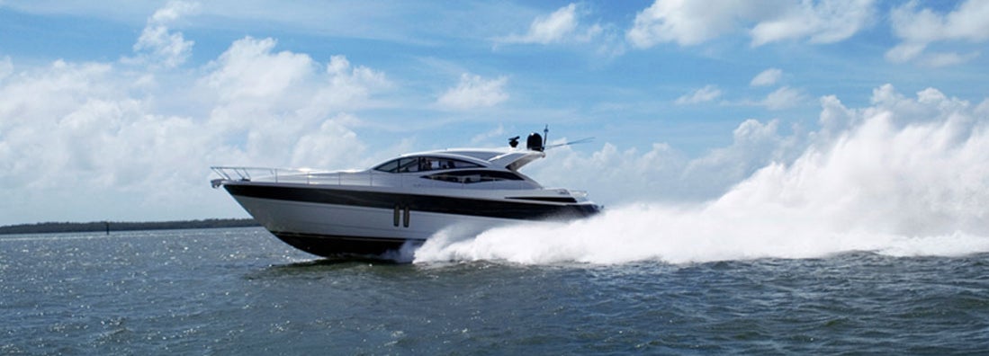 Yacht speeding on lake. Find Michigan boat insurance.