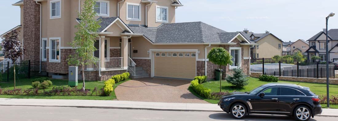 Suburban house in sunny summer afternoon. Find California umbrella insurance.