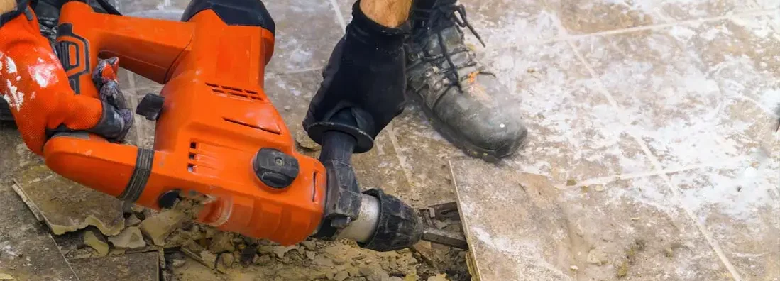 Preparation of repair the bathroom by removing old tiles with jackhammer. Find Demolition Contractor Insurance. 