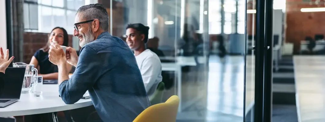 Businessman attending a meeting with his team. Find Northbrook, Illinois business insurance.