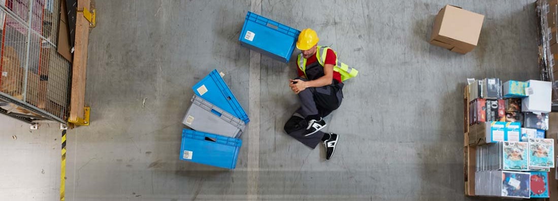 Man lying on the floor. Accident in warehouse