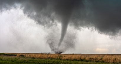 A tornado spins in a field beneath a supercell thunderstorm during a severe weather event in the midwest. 16 Absolutely Essential Tornado Survival Tips for South Dakota.