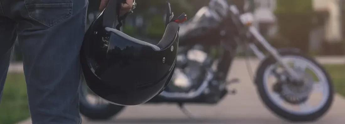 Motorcycle driver and helmet. Find Oregon motorcycle insurance.