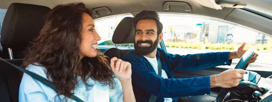 Couple driving car and talking. Is Insurance for an Old Car Necessary?