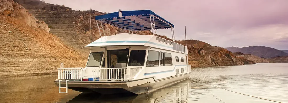 Houseboat on Lake Mead Nevada with cloudy sky. Find Nevada Boat Insurance.