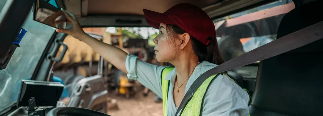 Female Truck Driver preparing to leave on road trip. Find Missouri Commercial Vehicle Insurance.