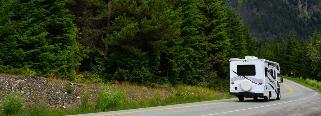 Motor home on road with mountains in background. Find Oregon RV Insurance.