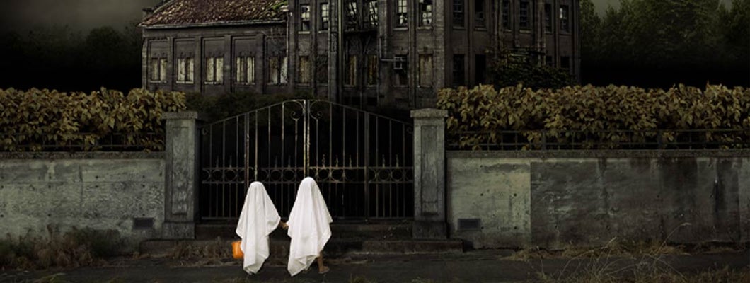 Children in Ghost Costumes Trick or Treat at Haunted House