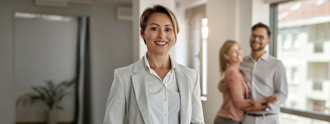 Landlord with a couple in the background. Find New York Landlord Insurance.