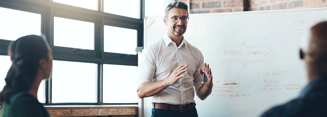 Business Consultant giving a presentation to a new business in boardroom