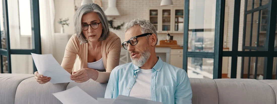 Couple taking care of their finances at home. Find Variable Life Insurance.