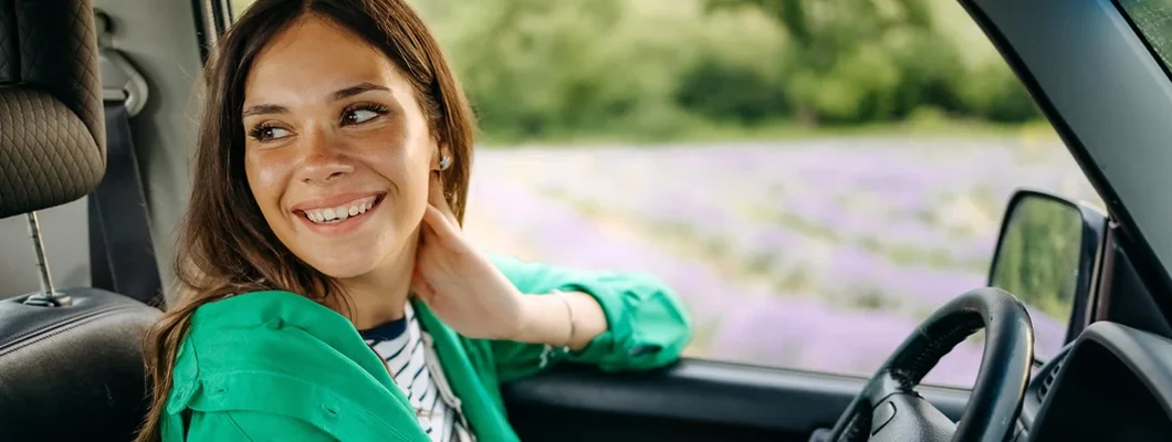 Woman in a car on a sunny spring afternoon. Mercer Island, Washington Car Insurance.