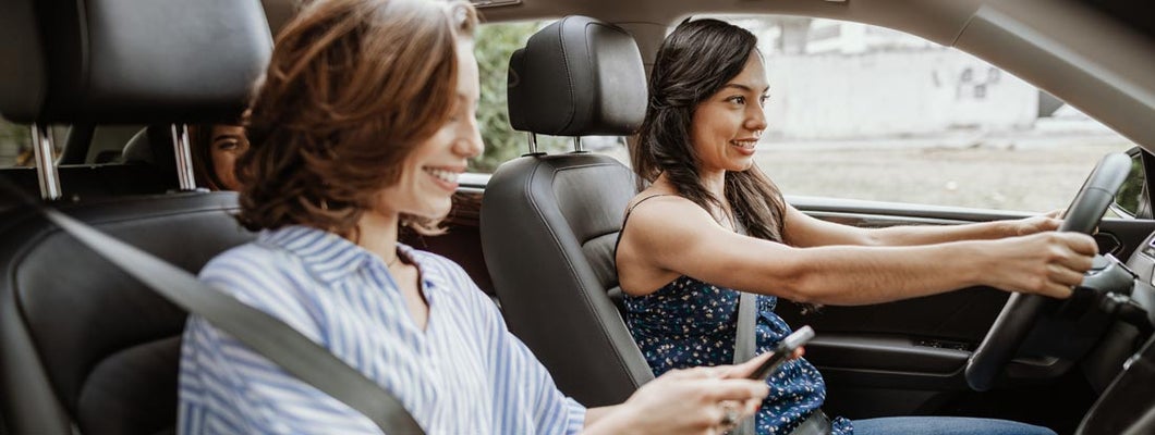 Young women sharing a ride to work together. Find Birmingham Alabama car insurance.