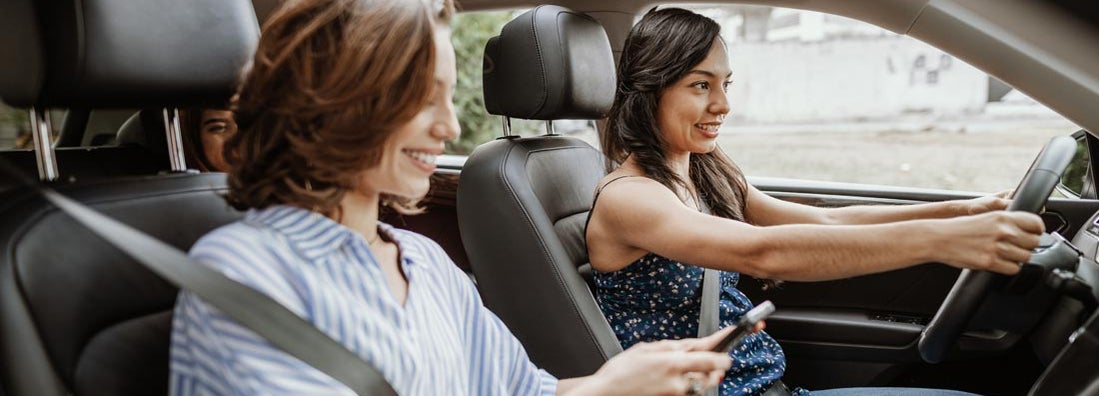 Young women sharing a ride to work together. Find Birmingham Alabama car insurance.