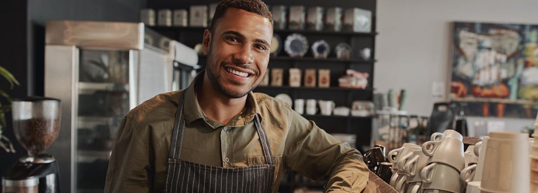 Barista standing at the counter of the coffee shop. Find Corinth, Mississippi business insurance.