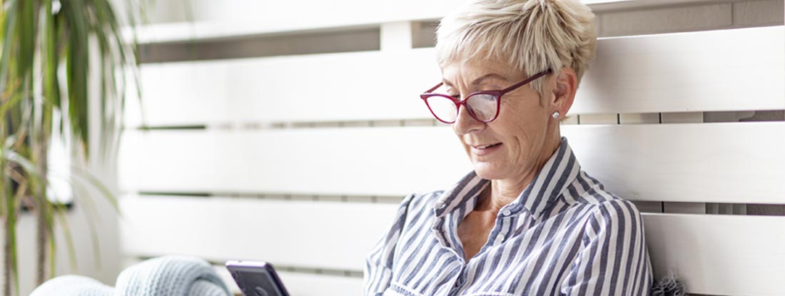 Woman using a phone. Find Health Insurance Claims.