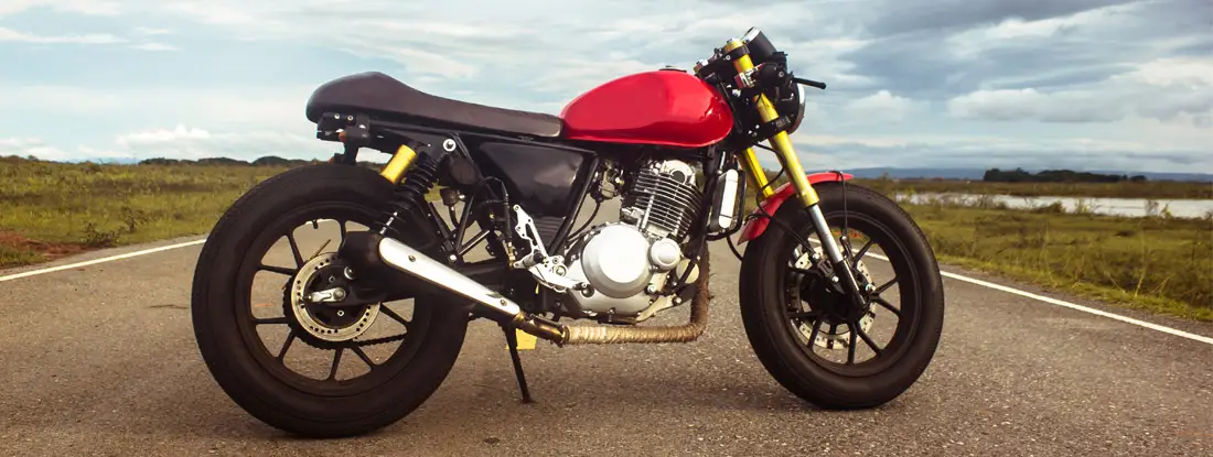 Vintage cafe racer motorcycle on the road. Motorcycle Insurance Bundles.