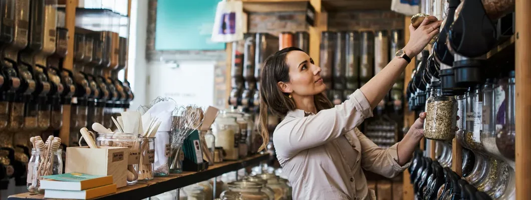 Shot of a young woman filling a jar with product while shopping. Business Insurance in Braintree, Massachusetts.