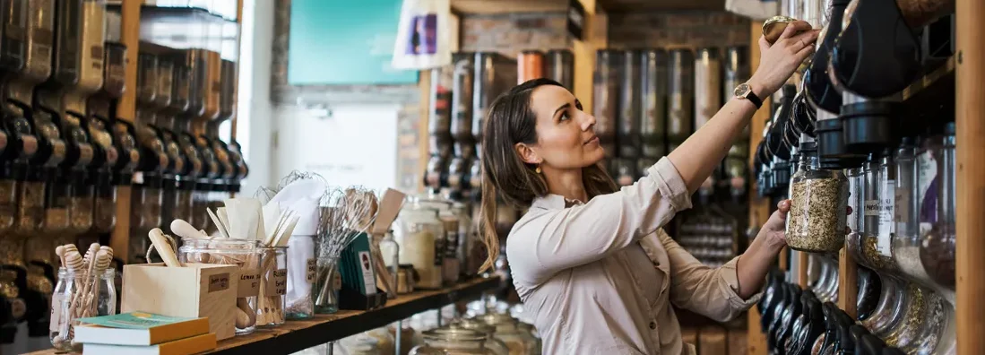 Shot of a young woman filling a jar with product while shopping. Business Insurance in Braintree, Massachusetts.