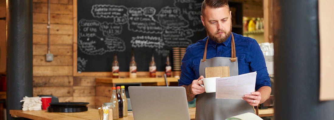 Restaurant owner reviewing insurance options. Find Business Insurance for Restaurants.