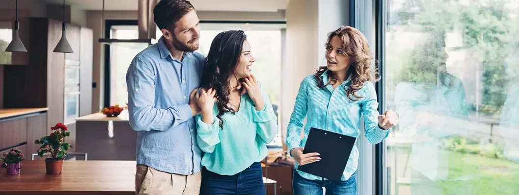 Landlord with a young couple in a new rental. Find California Landlord Insurance.