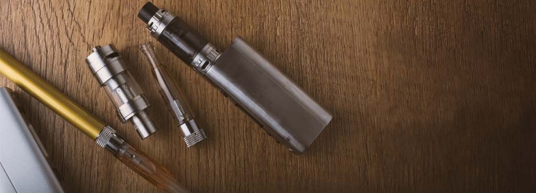 vaping devices, atomizers for electronic cigarette on a wooden banner background
