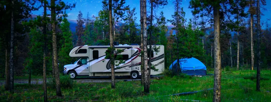 Motorhome Under The Stars In Nature Forest. Find Idaho RV Insurance.