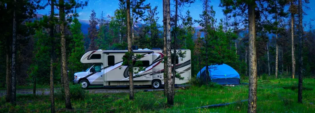 Motorhome Under The Stars In Nature Forest. Find Idaho RV Insurance.