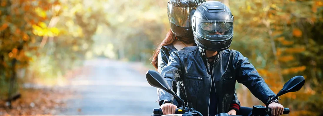 Couple biker riding motorcycle. Find West Virginia Motorcycle Insurance.
