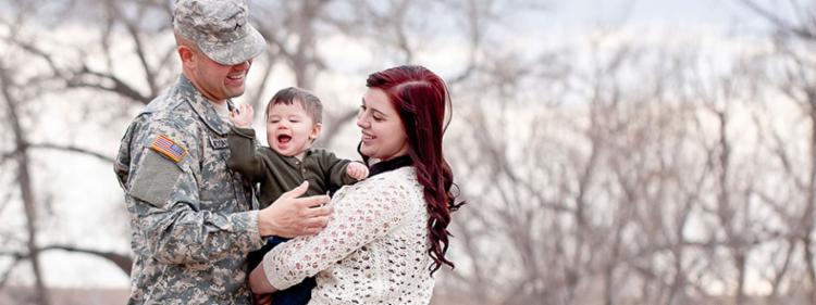 Man on leave from the army with his wife and young son.