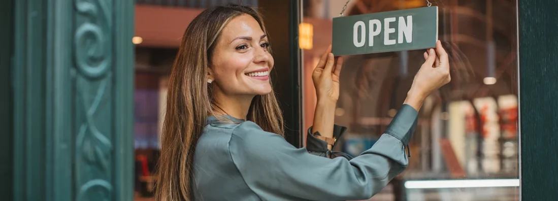 Young woman opening her store and waiting for customers. Waukee, Iowa Business Insurance.