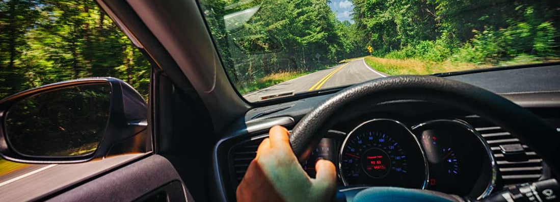 Driver's perspective on a road trip through a country road. Find Bowling Green Kentucky car insurance.