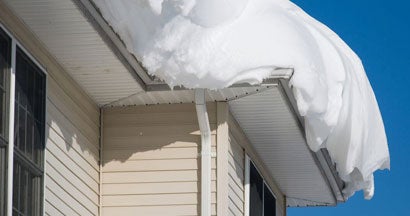 Thick pile of snow on the rooftop of a house. How Much Snow Is Too Much on an Illinois Home’s Roof?