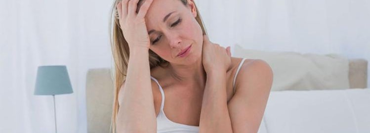 Woman in bed with neck pain