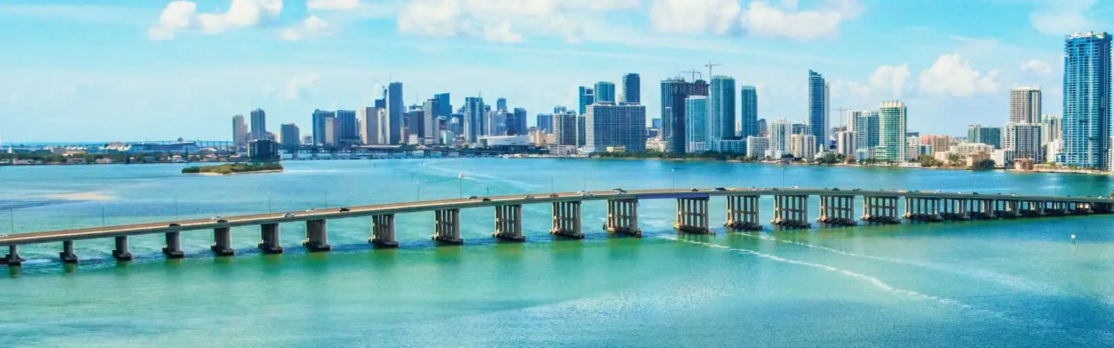 A panoramic view of the downtown skyline of Miami, Florida from over the Biscayne Bay. Find Florida Insurance