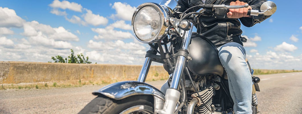 Cropped photo of biker in leather jacket on motorcycle. Find Montana Motorcycle Insurance.