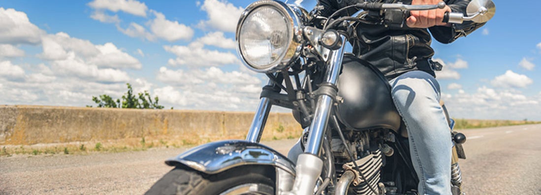 Cropped photo of biker in leather jacket on motorcycle. Find Montana Motorcycle Insurance.