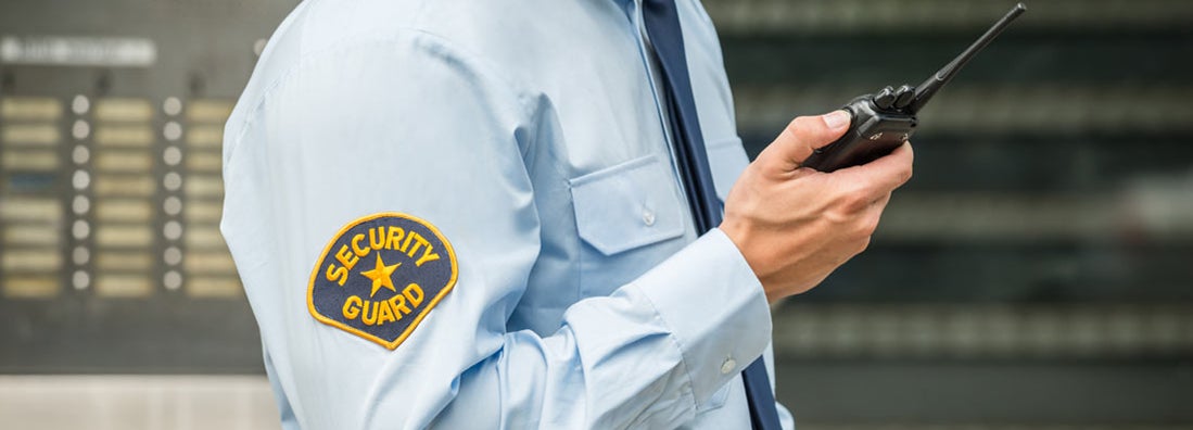 Security Guard Using Handheld Radio. Find Security Guard Insurance.