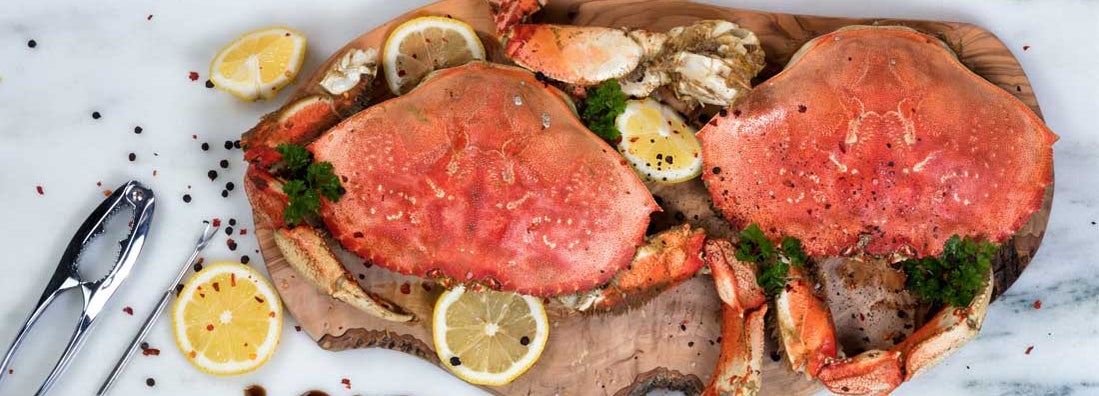 Freshly cooked crab with spices on wooden server