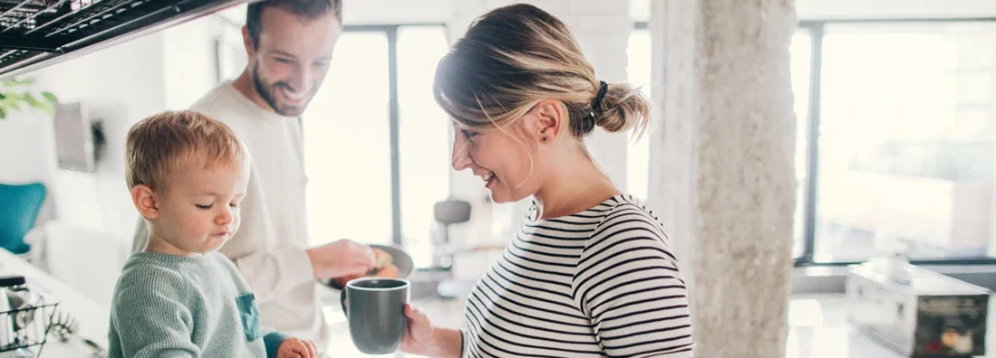 Young family preparing breakfast together in their kitchen. Find New Jersey Life Insurance.