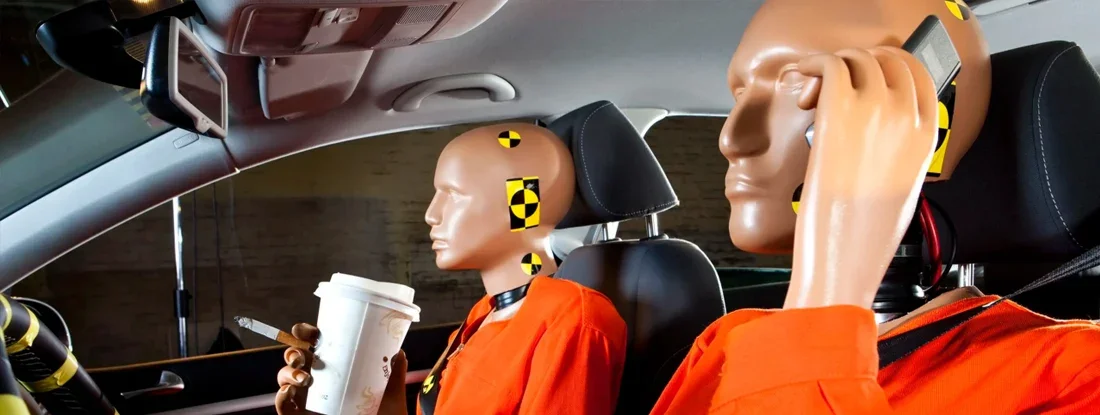 Crash test dummy using a mobile phone while driving with a crash test dummy passenger. Are Crash Test Dummies Really Like People?
