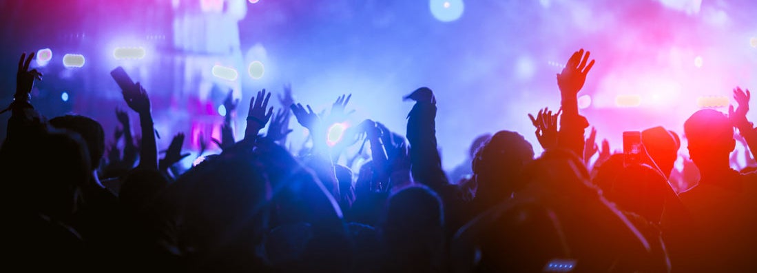 Silhouettes of hand in concert.Light from the stage. Find Nightclub Insurance.