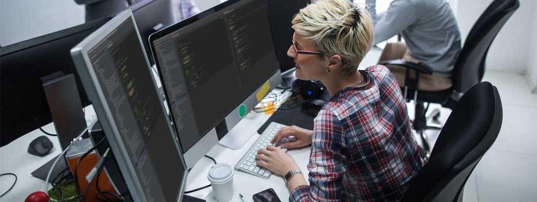 Female computer programmer working on computer. Find Computer Programmer & IT Consultant Insurance.